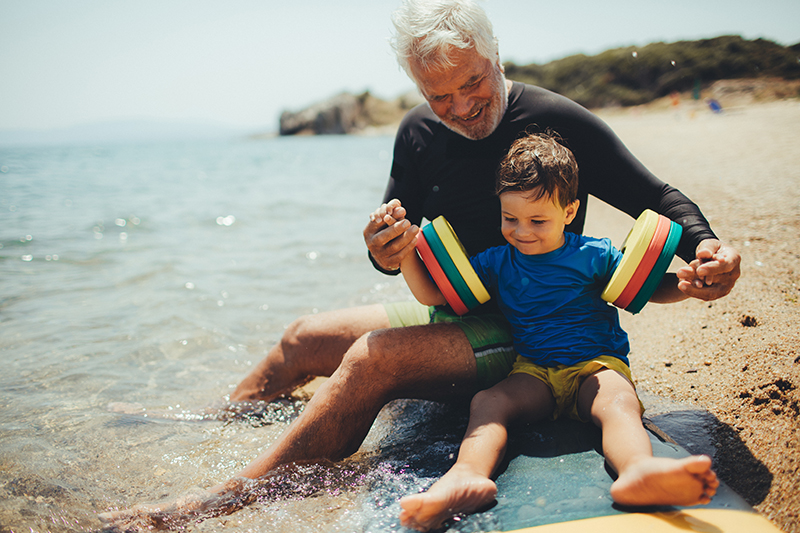 image of grandfather and grandson at the beach